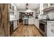 Spacious kitchen with stainless steel appliances, white cabinetry, and hardwood flooring at 5015 N Park Ave, Indianapolis, IN 46205