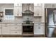Elegant kitchen with stainless steel appliances, white cabinets, and tile backsplash at 5015 N Park Ave, Indianapolis, IN 46205