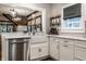 Bright kitchen area with a farmhouse sink, stainless steel appliances, and open shelving at 5015 N Park Ave, Indianapolis, IN 46205