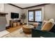 Cozy living room with hardwood floors, decorative fireplace, and comfortable seating at 5015 N Park Ave, Indianapolis, IN 46205