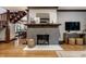 Stylish living room featuring a fireplace, wood floors, and view to dining room at 5015 N Park Ave, Indianapolis, IN 46205