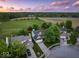 Aerial view of a house with a large lawn, set in a neighborhood with a country-like backdrop at 5041 Millwright Ct, Indianapolis, IN 46254
