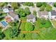 Aerial view of a home and fenced backyard with mature trees, a well-manicured lawn, and concrete patio at 5041 Millwright Ct, Indianapolis, IN 46254
