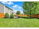 Lush backyard with a spacious grass area, patio, and wooden fence, creating a private outdoor space at 5041 Millwright Ct, Indianapolis, IN 46254