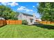 Green backyard featuring a spacious lawn, patio area, and wooden fence, perfect for relaxation and activities at 5041 Millwright Ct, Indianapolis, IN 46254
