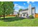 Backyard view of a home with a patio and a green lawn, surrounded by a wooden fence at 5041 Millwright Ct, Indianapolis, IN 46254