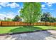 Backyard featuring a well-maintained lawn, a privacy fence, a concrete patio, and trimmed greenery at 5041 Millwright Ct, Indianapolis, IN 46254