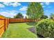 Spacious backyard with lush green grass, a wooden fence, and a tree, ideal for outdoor activities at 5041 Millwright Ct, Indianapolis, IN 46254