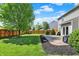 Well-maintained backyard with a mix of grass, mulch beds, and a patio area perfect for entertaining at 5041 Millwright Ct, Indianapolis, IN 46254