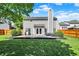 Backyard view with a patio, grill area, lush lawn, and a wooden fence for added privacy at 5041 Millwright Ct, Indianapolis, IN 46254