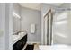 Bright bathroom with double sinks, a shower with glass door, and a large mirror at 5041 Millwright Ct, Indianapolis, IN 46254