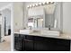 Bright bathroom featuring double sinks, modern fixtures, and a large mirror for a luxurious feel at 5041 Millwright Ct, Indianapolis, IN 46254