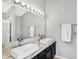 Bright bathroom featuring double sinks, stylish faucets, and a shower at 5041 Millwright Ct, Indianapolis, IN 46254