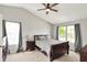 Primary bedroom featuring a bed, windows with curtains and a ceiling fan at 5041 Millwright Ct, Indianapolis, IN 46254