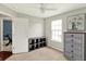 Bright bedroom featuring natural light, neutral carpet, and dark stained storage unit at 5041 Millwright Ct, Indianapolis, IN 46254
