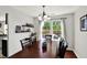 An inviting dining room with a wooden table, modern lighting, and a window with a peaceful view at 5041 Millwright Ct, Indianapolis, IN 46254