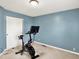 Comfortable exercise room featuring a stationary bike and blue accent wall, creating an ideal workout space at 5041 Millwright Ct, Indianapolis, IN 46254
