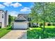 Charming two-story home with a two-car garage, a well-manicured lawn, and mature trees at 5041 Millwright Ct, Indianapolis, IN 46254