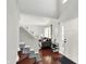 Bright entry foyer with hardwood floors, staircase, and view into the living area at 5041 Millwright Ct, Indianapolis, IN 46254