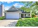 Charming two-story home featuring a two-car garage, covered porch, and a well-maintained front lawn at 5041 Millwright Ct, Indianapolis, IN 46254