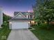 Charming home with a two-car garage, well-manicured lawn, and a lovely front porch at 5041 Millwright Ct, Indianapolis, IN 46254