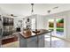 Bright kitchen with a large center island, stainless steel appliances and easy access to a cozy living room at 5041 Millwright Ct, Indianapolis, IN 46254