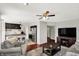 Inviting living room with ceiling fan, leading to a kitchen with modern countertops and stainless steel appliances at 5041 Millwright Ct, Indianapolis, IN 46254