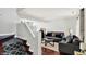 Cozy living room with modern gray sofas, hardwood floors, and staircase at 5041 Millwright Ct, Indianapolis, IN 46254