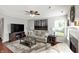 Relaxing living room featuring a ceiling fan, neutral sofa, fireplace, and stylish decor at 5041 Millwright Ct, Indianapolis, IN 46254