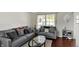 Comfortable living room featuring modern gray sofas, throw pillows, and a stylish glass-top coffee table at 5041 Millwright Ct, Indianapolis, IN 46254
