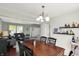 The open plan living room with a dark wood dining table and seating at 5041 Millwright Ct, Indianapolis, IN 46254
