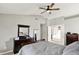 Spacious primary bedroom leading to bathroom, bed, and large window with curtain at 5041 Millwright Ct, Indianapolis, IN 46254