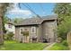 Well-maintained backyard with a patio, stone fireplace, and lush green lawn, ideal for entertaining or enjoying a quiet retreat at 5117 N Park Ave, Indianapolis, IN 46205