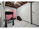 Unfinished basement with a painted brick wall, a small window, and visible beams and piping at 5117 N Park Ave, Indianapolis, IN 46205