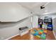 Spacious basement featuring wood floors, neutral walls, and a storage area with shelving and laundry hookups at 5117 N Park Ave, Indianapolis, IN 46205