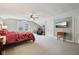 This is a bedroom with neutral carpet, ceiling fan, and wall-mounted tv at 5117 N Park Ave, Indianapolis, IN 46205