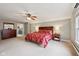 This is a bedroom with neutral carpet, ceiling fan, and cherry wood bedroom furniture set at 5117 N Park Ave, Indianapolis, IN 46205