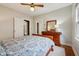 The bedroom features wood floors, white walls, and a bed with patterned bedding at 5117 N Park Ave, Indianapolis, IN 46205
