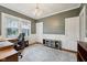 This is a bedroom with two windows, a desk and chair, and a light gray accent wall at 5117 N Park Ave, Indianapolis, IN 46205