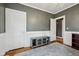 This is a bedroom with a chandelier, wood floors, and a light gray accent wall at 5117 N Park Ave, Indianapolis, IN 46205