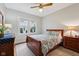 The bedroom features a wood-framed bed with blue and white patterned bedding and a ceiling fan at 5117 N Park Ave, Indianapolis, IN 46205