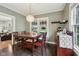 The dining room features hardwood floors, a wooden table, and a drink cabinet at 5117 N Park Ave, Indianapolis, IN 46205