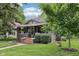 Quaint home featuring a brick stairway leading to a charming front porch and well-kept lawn at 5117 N Park Ave, Indianapolis, IN 46205