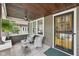 Inviting front porch with seating area, ceiling fan, and decorative door for a welcoming entrance at 5117 N Park Ave, Indianapolis, IN 46205