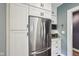 The kitchen features stainless appliances and white cabinetry at 5117 N Park Ave, Indianapolis, IN 46205