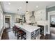 The kitchen features gray cabinetry, an island with seating, and stainless appliances at 5117 N Park Ave, Indianapolis, IN 46205