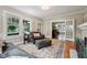 Spacious living room with hardwood floors, neutral decor, and seamless flow to the dining area at 5117 N Park Ave, Indianapolis, IN 46205