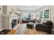 Cozy living room features a fireplace, plush seating, and natural light from large windows at 5117 N Park Ave, Indianapolis, IN 46205