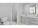 Bathroom features a modern glass-enclosed shower, gray vanity, and neutral color scheme at 5353 Chipwood Ln, Indianapolis, IN 46226