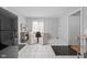 Bright dining area with white tile flooring, table with four chairs, and access to the laundry area at 5353 Chipwood Ln, Indianapolis, IN 46226